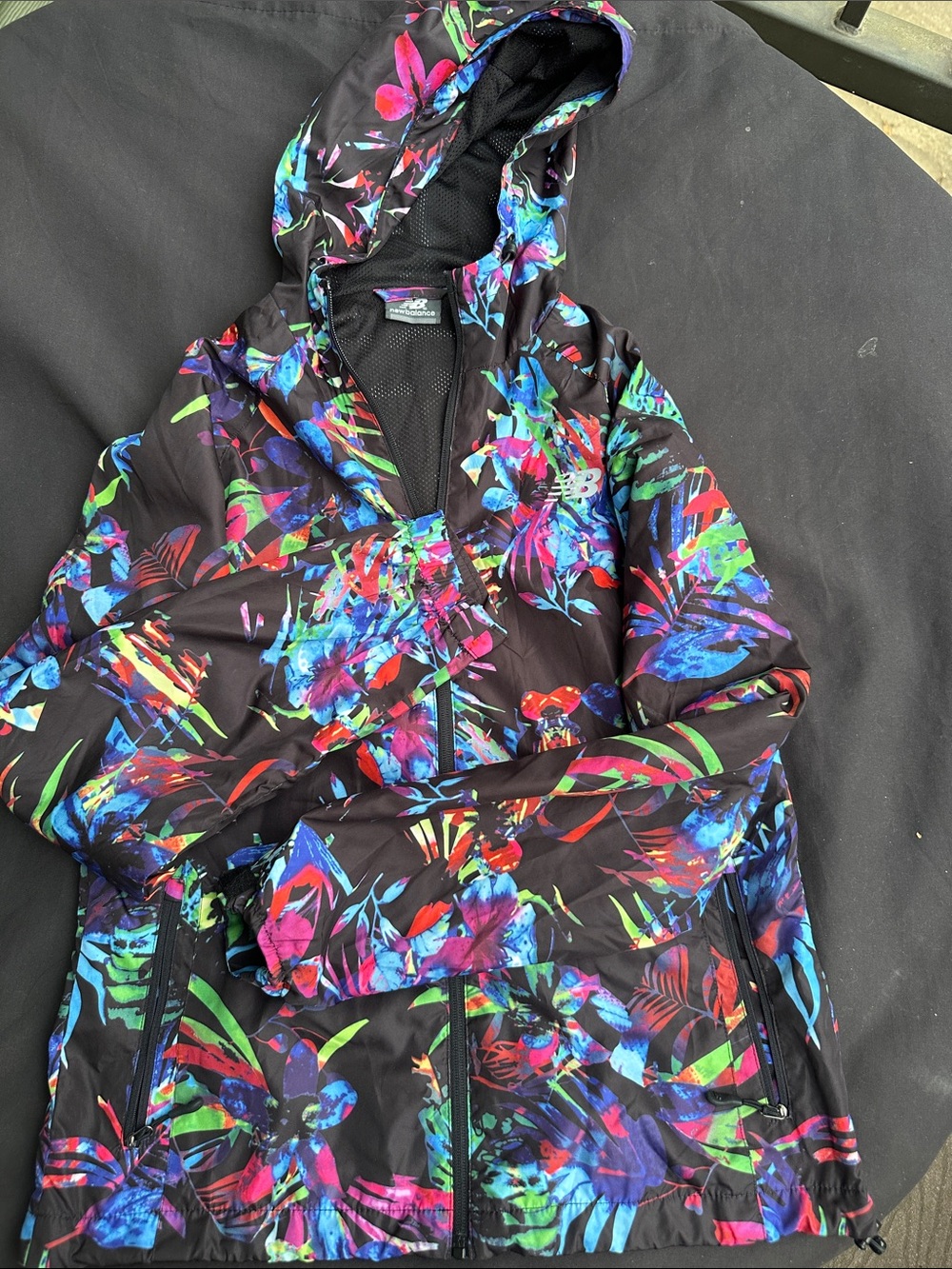 New Balance Black Hooded Kids Jacket with Multicolor Floral Print.